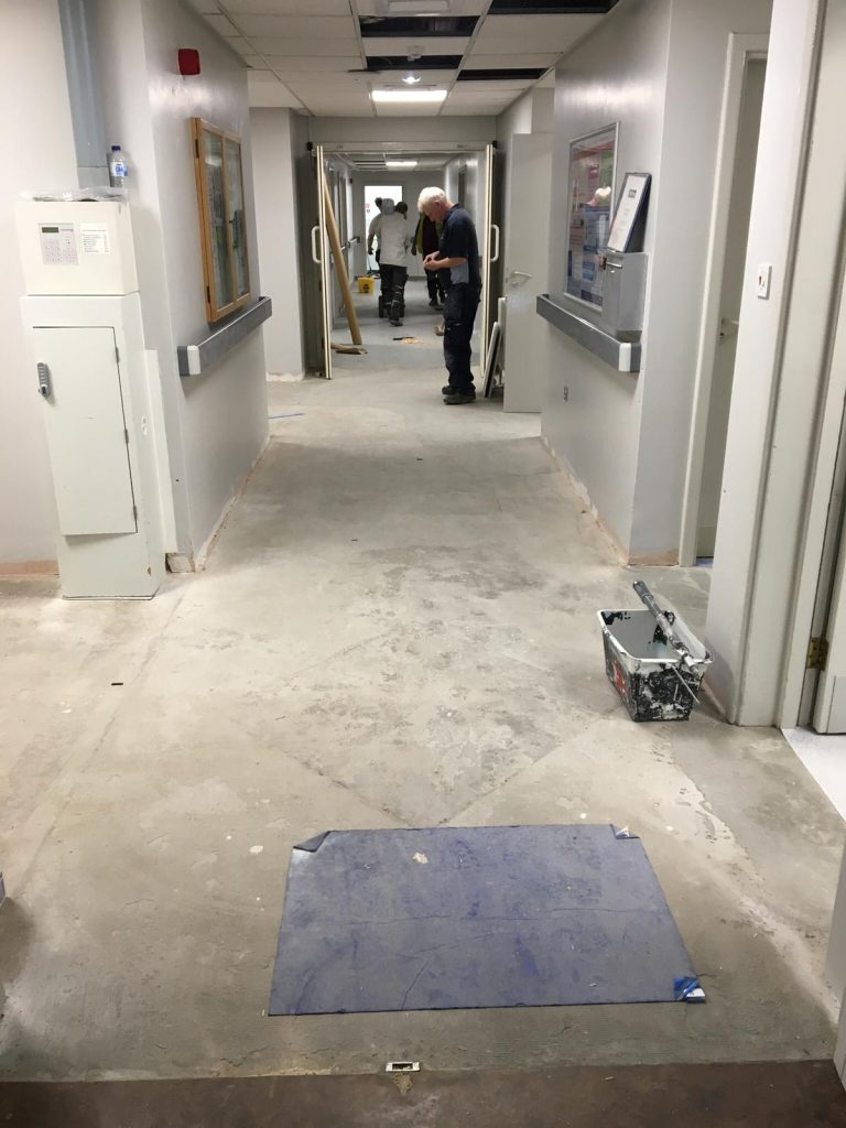 Preparing the subfloor in the ward corridor at Firth 8, Northern General hospital
